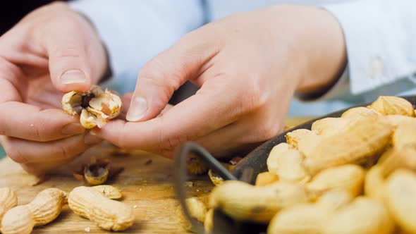 The Woman Peels the Peanuts From the Retro Tray