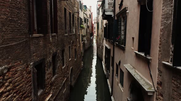 A Narrow Space Between Old Traditional Houses Above One of the Venice Canals