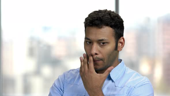 Distrustful Young Man Looking at Camera with Disbelief