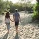 Young couple walking along sand - VideoHive Item for Sale