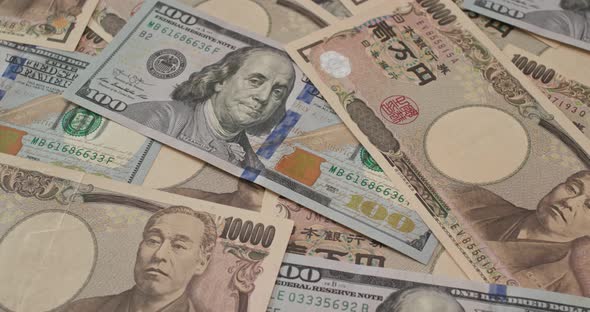 Stack of American USD and Japanese Yen banknote