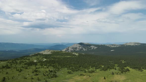 Mountain range and green valley from bird's height