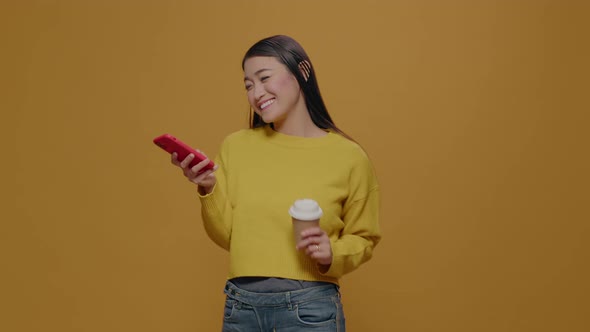 Happy Person Holding Smartphone and Cup of Coffee