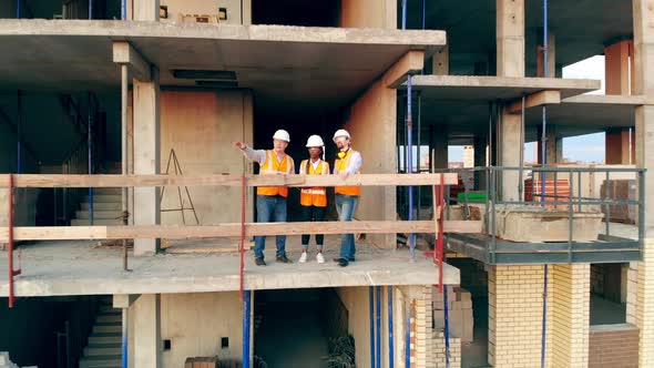 Multiethnic Engineers, Architects Discussing Construction Plan. Builders Check House on a alt