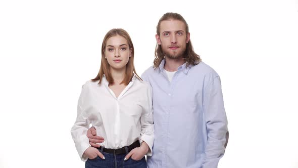  Young Caucasian Couple Huging and Smiling on White Background