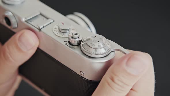 Close up Photographer Prepares Vintage Film Camera and Press the Button.