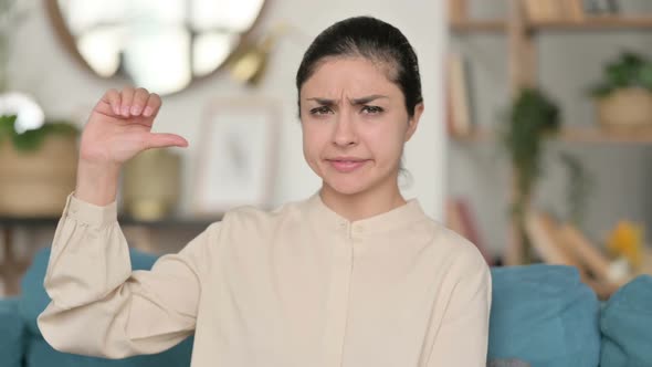 Indian Woman with Thumbs Down at Home