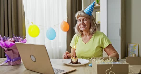 Cheerful Senior Woman Making Video Call During Birthday Celebration