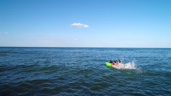 Green Sea in Which Mom and Daughters Swim