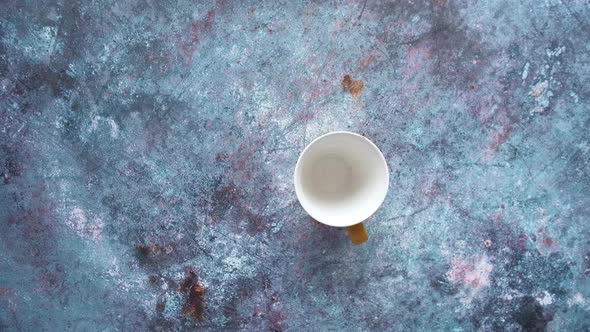 Top View of Man's Hand Putting Colorful Toothbrushes in a Mug