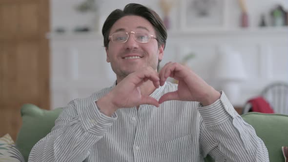 Portrait of Man Showing Heart Sign by Hand