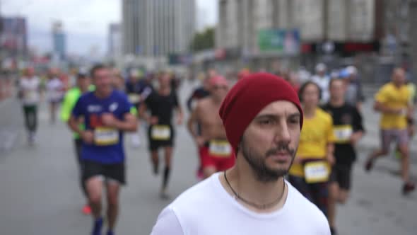 Robust Guy Runner on Sports Event Run with Crowd of Athletes on Marathon Race