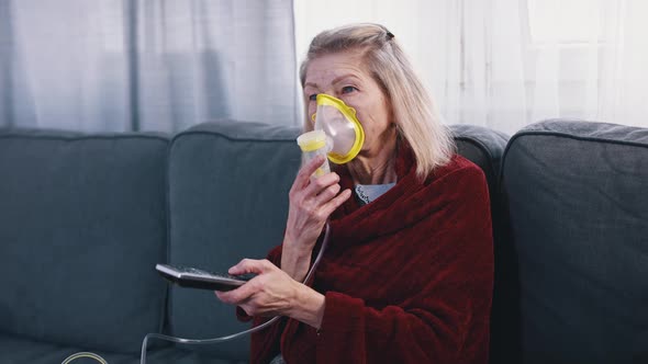 Senior Caucasian Woman Using Inhaler While Watching Tv