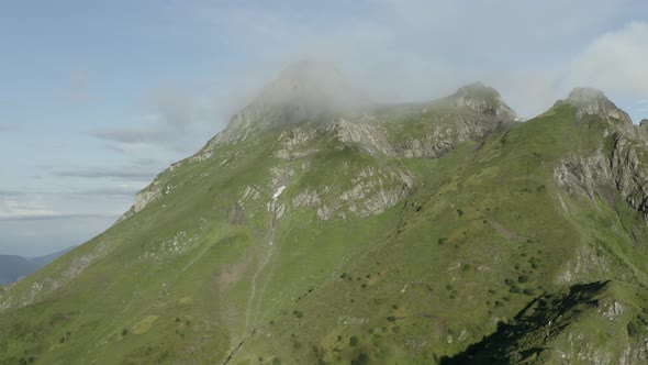 Shooting From Drone Gorgeous Natural Cliff Summit at Smoke Cloud Surrounded By Sunny Landscape