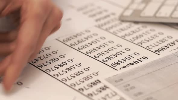 The Businessman Examines Documents with Diagrams and Graphs.