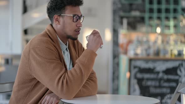 African Man Feeling Upset While Reading Papers