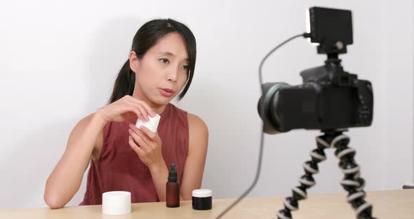 Woman taking video of making vlog at home