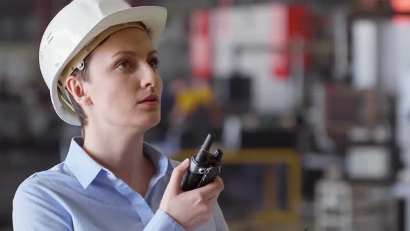 Female Engineer Talking on Portable Radio