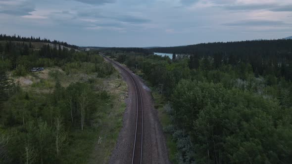 Empty train track running through the stunning landscapes of Kananaskis Country in Alberta, Canada.