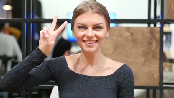 Young Girl  Showing Victory Sign, Portrait