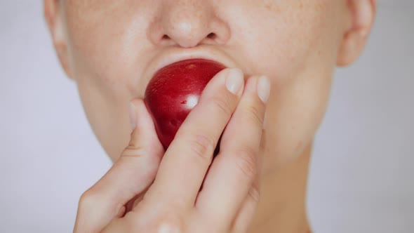 Close Up Face Young Woman Eating Plum