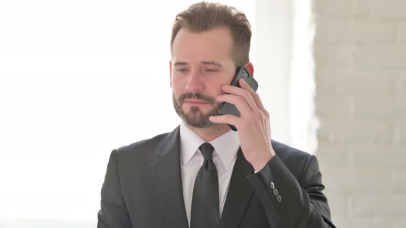 Young Businessman Talking on Phone Discussion
