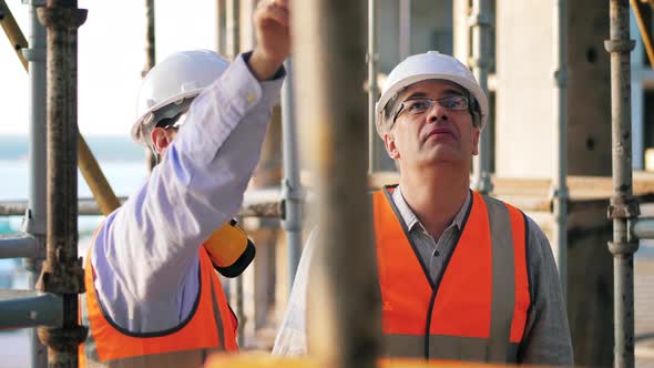 Male Engineers Talking on a Construction Site alt