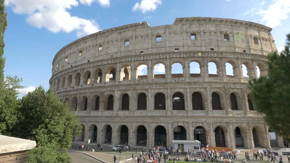 Tourists passing by the Colosseum in Rome