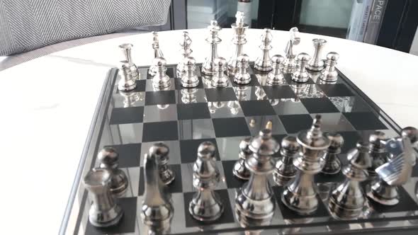 Luxurios Black and Silver Chess Board on the Marble Desk