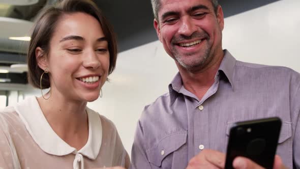 Business people discussing over mobile phone in modern office 4k