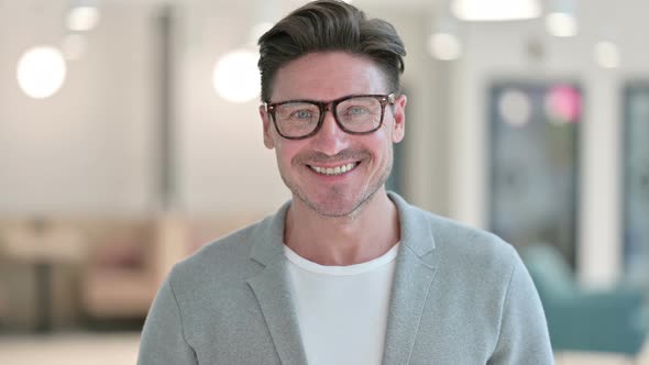 Portrait of Cheerful Middle Aged Man Smiling at Camera