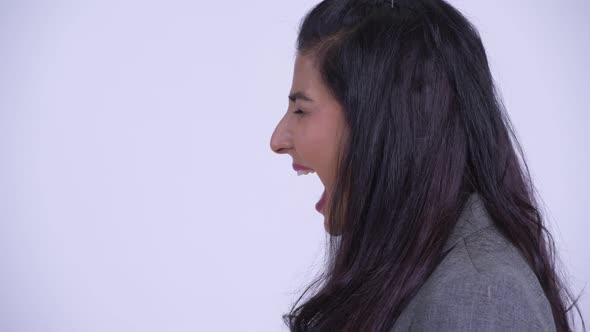 Closeup Profile View of Young Angry Persian Businesswoman Shouting and Screaming