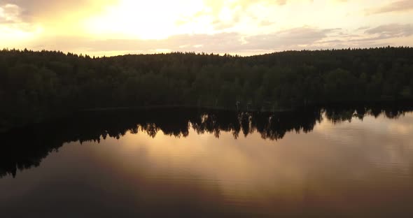 A n aerial shot of a sunset by the lake in Finland