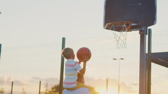 Young family playing basketball