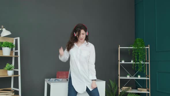 Businesswoman Singing and Dancing Taking a Break From Work and Having Fun