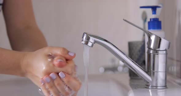 Woman Washing Her Hands at the Bathroom With Water, Antibacterial Soap and Foam, coronavirus