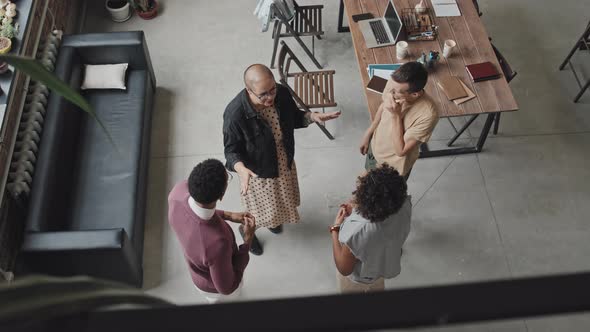 Woman Talking to Colleagues Top View