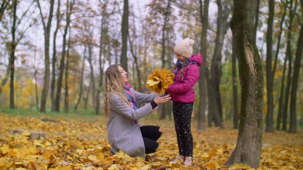 Cheerful Mother and Daughter Enjoying Fall Season