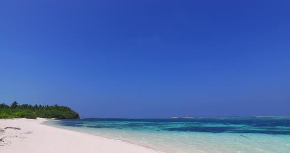 Beautiful above clean view of a white sand paradise beach and aqua blue ocean background in colourfu