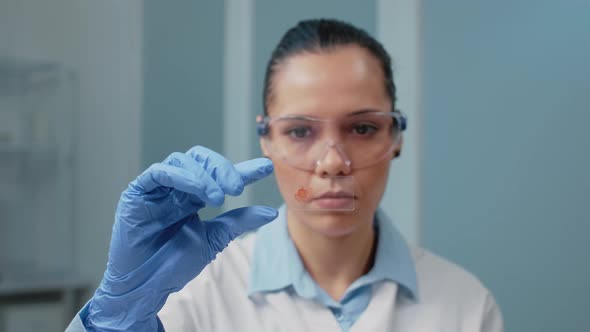 Portrait of Doctor in Laboratory Analyzing Blood Sample