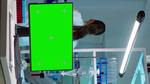 Vertical Video Chemists Working in Background of Lab Using Pc with Green Screen