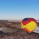 Aerial Shot of the People Fly on a Big Bright Balloon Over the Winter Forest - VideoHive Item for Sale