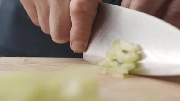 Front View of the Young Chef Cut Thin Slices of a Piece of Green Pepper