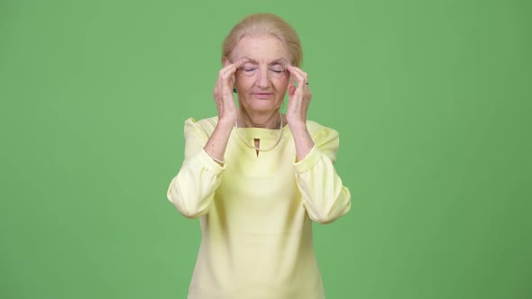Stressed Senior Businesswoman Having Headache