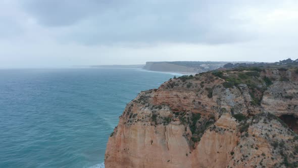 Aerial Drone View of Spectacular Lagos Rocky Atlantic Coastline Seagull Flying Portugal Dolly in