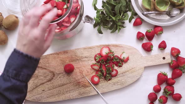 Step by step. Slicing fresh organic fruits for infused water.