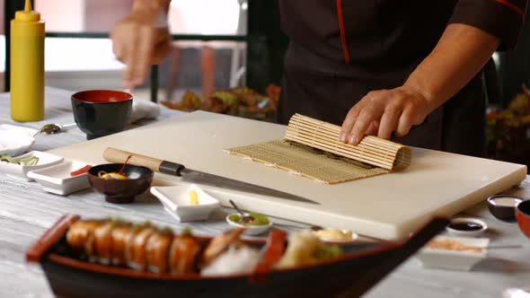 Male Hands Make Sushi.