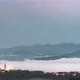Fog Coming Down from Mountain Range to Village at Sunset - VideoHive Item for Sale