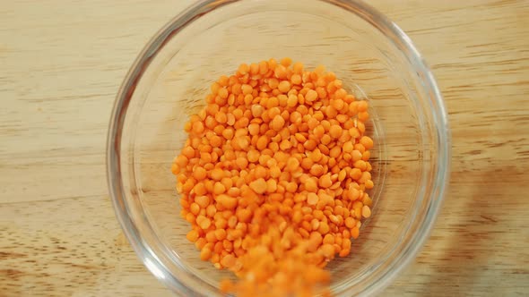 Pouring Yellow Lentils Into a Bowl