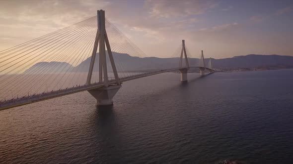 Aerial view of the Rion-Antirion Bridge at sunset in Greece.